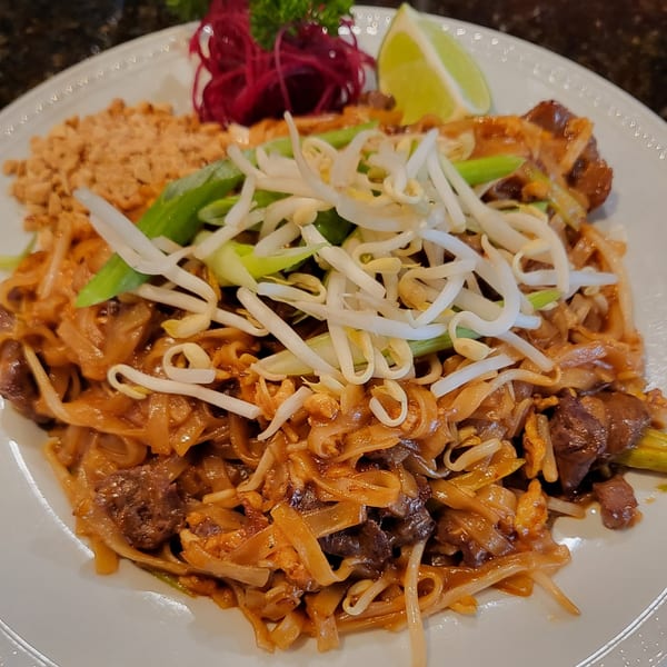 Nakama Sushi Thai's Pad See Ew with beef, wide noodles, bean sprouts, green onions, and lime.